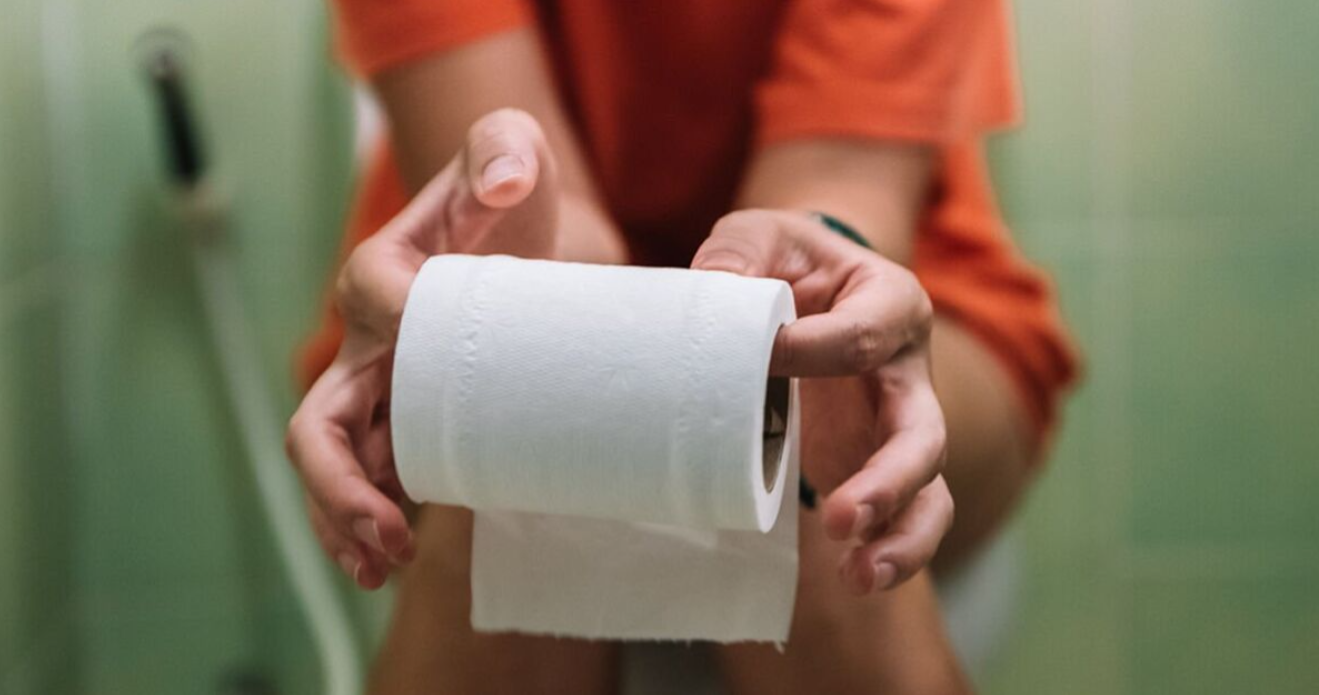 A person holding a toilet roll